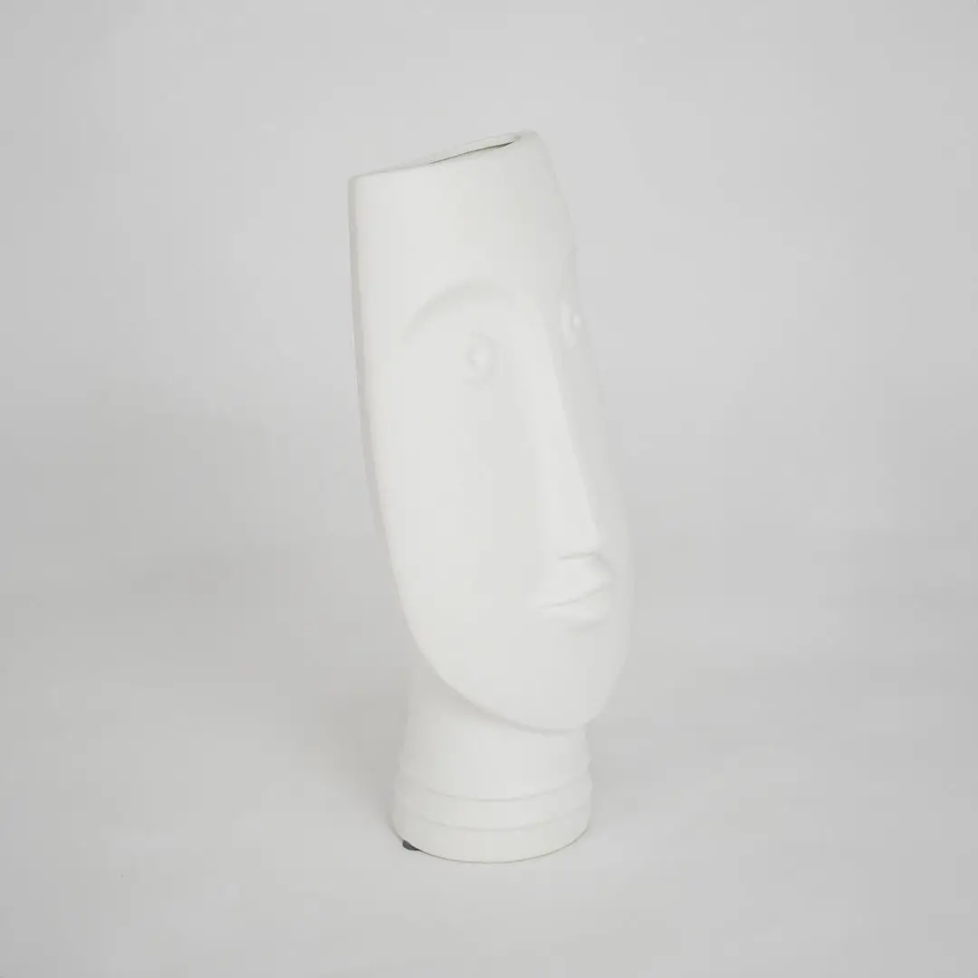 White sculptural ceramic vase for modern shelf placement and elegant indoor home decor styling accent piece.