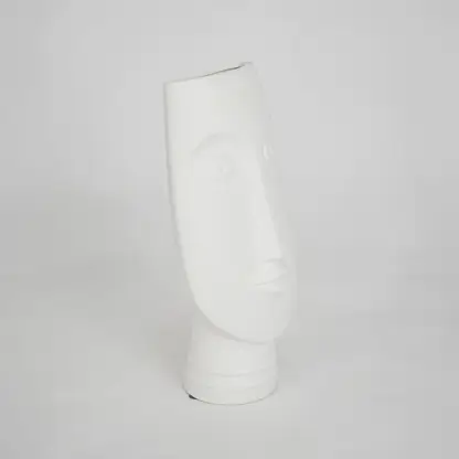 White sculptural ceramic vase for modern shelf placement and elegant indoor home decor styling accent piece.