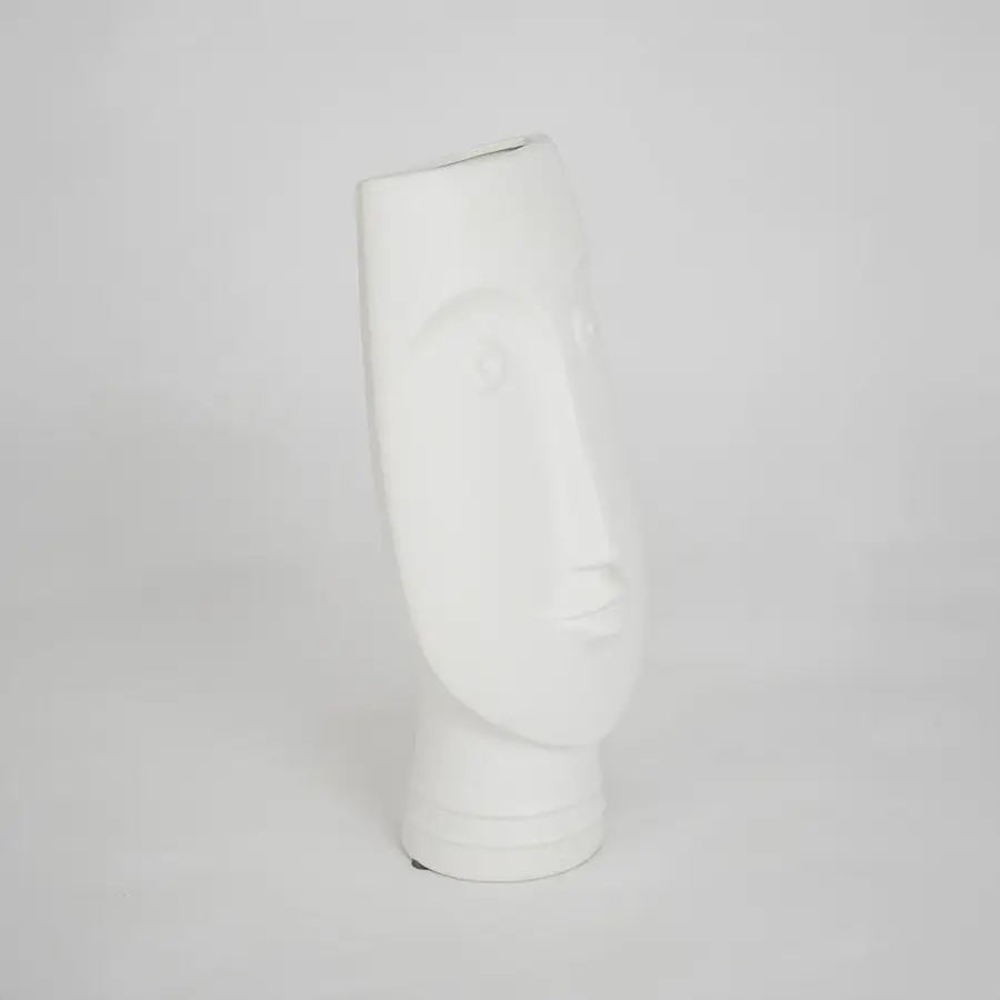 White sculptural ceramic vase for modern shelf placement and elegant indoor home decor styling accent piece.