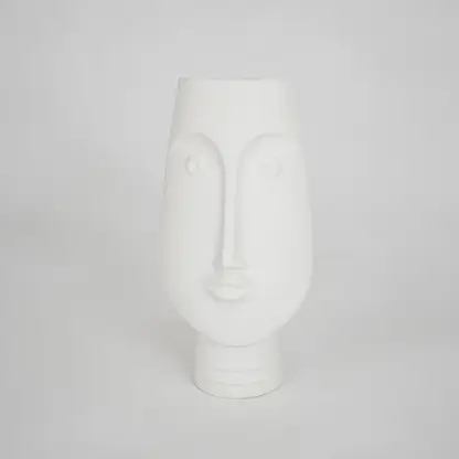 White sculptural ceramic vase for stylish shelf placement and modern living room decor styling accent piece.