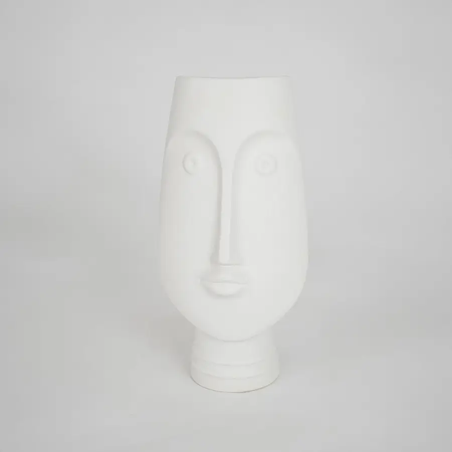 White sculptural ceramic vase for stylish shelf placement and modern living room decor styling accent piece.