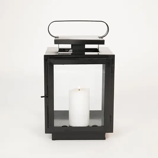 White background image of small metal tower lantern for elegant table decor styling with sleek metallic finish.