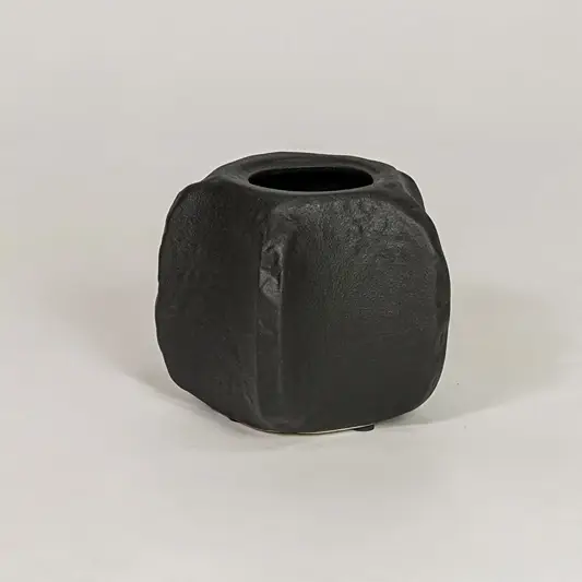 Black ceramic decorative planter with sculpted matte finish for modern tabletop shelf and console decor placement.