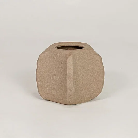 Brown ceramic planter with textured matte finish for modern tabletop shelf and console decor placement.