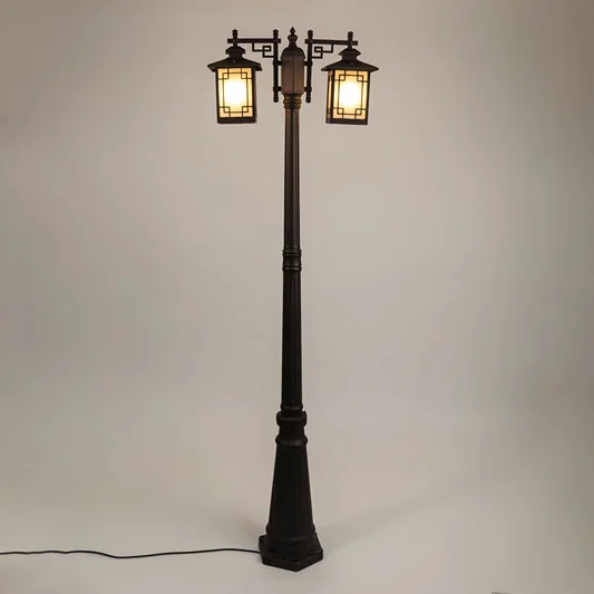 Vintage outdoor street lamp with dual glowing lanterns for elegant exterior decor styling use.