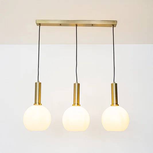 White glass and gold metal pendant lights showcasing stylish designs for contemporary home decor.
