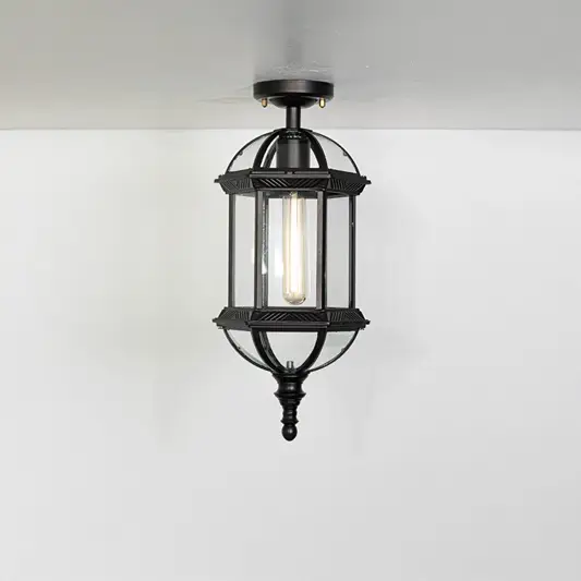 Vintage black metal lantern ceiling light with exposed bulb for classic entryway and traditional decor spaces.