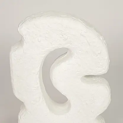 Closeup of white ceramic abstract decor sculpture with textured finish for elegant tabletop styling ideas.