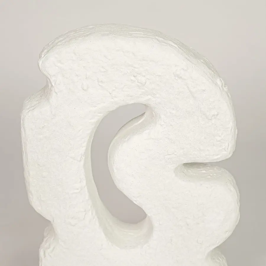 Closeup of white ceramic abstract decor sculpture with textured finish for elegant tabletop styling ideas.