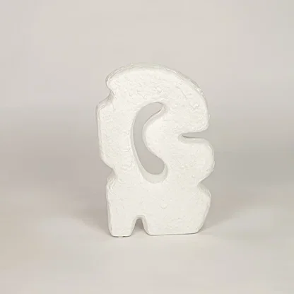 White ceramic abstract decorative sculpture with textured finish for modern shelf tabletop and console decor.