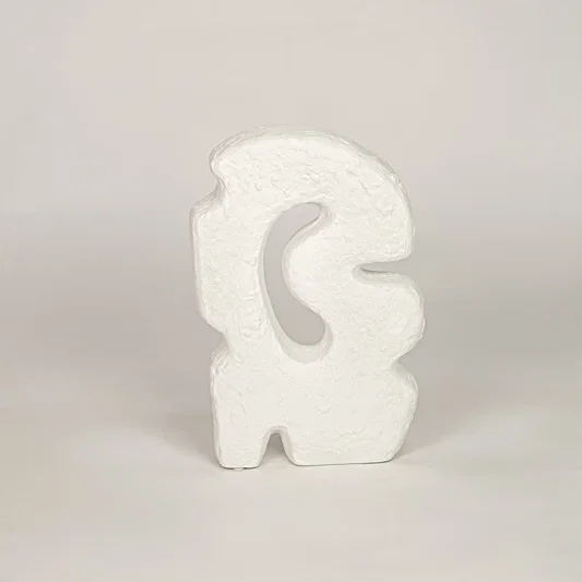 White ceramic abstract decorative sculpture with textured finish for modern shelf tabletop and console decor.