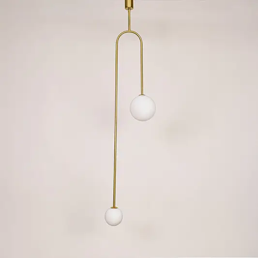 Gold metal pendant light with frosted globe glass shade designed for elegant modern ceiling lighting in homes.