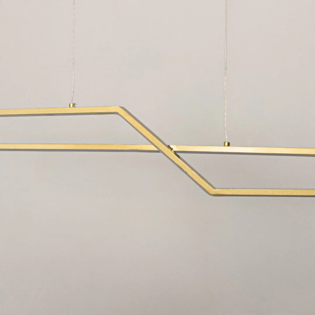 Geometric gold metal chandelier closeup highlighting angular linear design and suspended structure for contemporary ceiling lighting style.