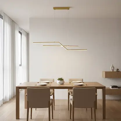 Gold metal linear pendant light styled above dining area creating sleek modern ceiling lighting for contemporary home interiors.