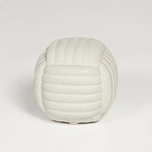 White ceramic textured decorative jar with rounded sculpted design isolated on clean white background for elegant tabletop display.