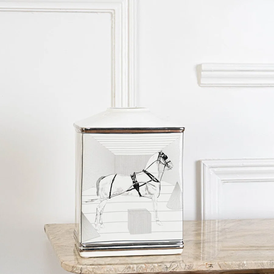 White ceramic jar with black galloping horse artwork in an angled view ideal for artistic décor and modern living room styling.