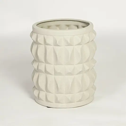 Modern light beige ceramic statement planter with embossed pattern for coffee table console or shelf styling.