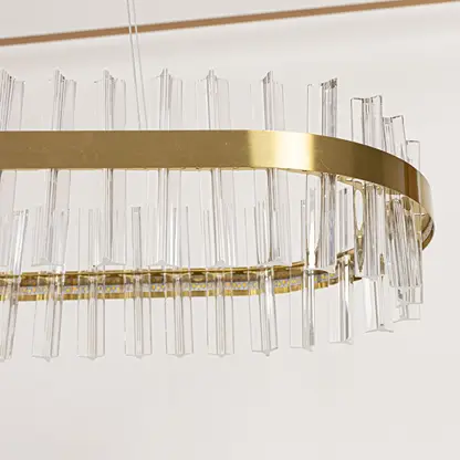 Closeup of gold metal chandelier highlighting the clear crystal rod detailing and elegant metallic frame crafted for luxurious modern lighting.