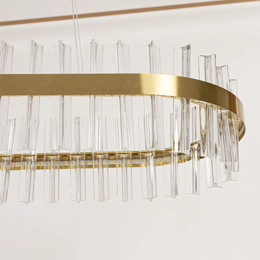 Closeup of gold metal chandelier highlighting the clear crystal rod detailing and elegant metallic frame crafted for luxurious modern lighting.