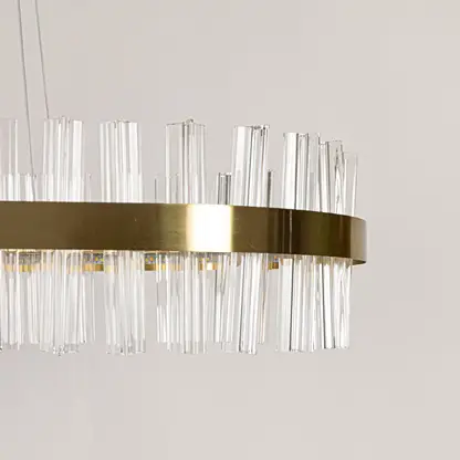 Closeup shot of gold metal chandelier focusing on its crystal textures and warm illumination for refined and elegant interior lighting.