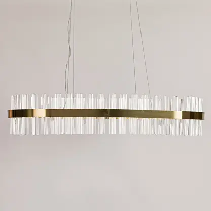 Gold metal chandelier with clear crystal rods displayed with lights off on a clean white background showcasing its sleek elongated shape.