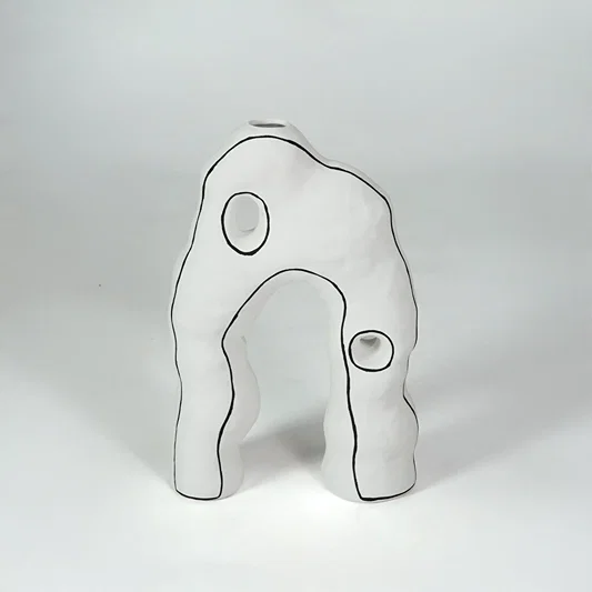 White abstract ceramic decor sculpture for modern shelf placement and artistic indoor home decor styling accent.