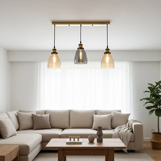 Amber and smoke glass pendant lights adding warm elegance above the sofa in modern interiors.