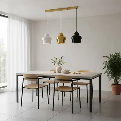 Mixed finish pendant lights creating warm ambience above the dining table in contemporary spaces.