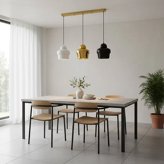 Mixed finish pendant lights creating warm ambience above the dining table in contemporary spaces.