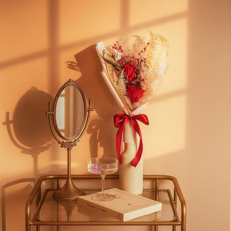 Infinity Rose Red bouquet displayed in hand-tied arrangement with preserved flowers red hydrangea and eucalyptus.