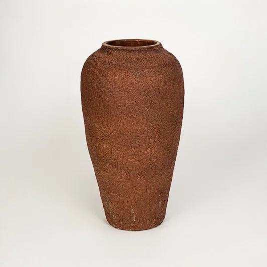 White background image of terracotta ceramic decorative vase for rustic floor placement with textured finish.