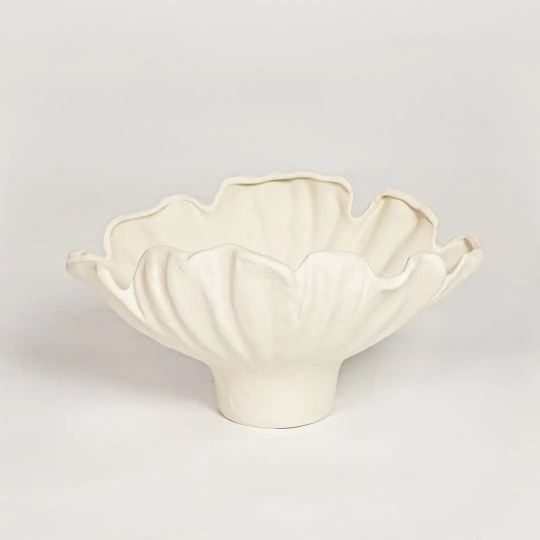 White ceramic floral decorative bowl with soft petal shape isolated on clean white background for contemporary interior decor use.