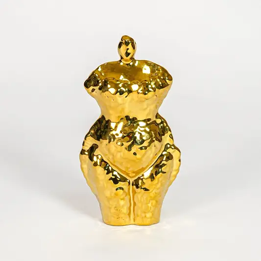 Gold decorative ceramic female sculpture on white background modern home decor accent piece for table shelf console styling.