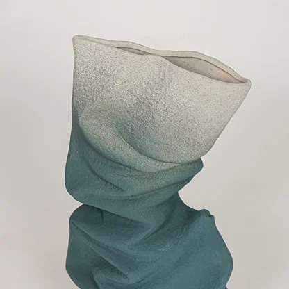Closeup of blue ceramic vase with textured twisted finish for elegant tabletop and shelf decor styling ideas.