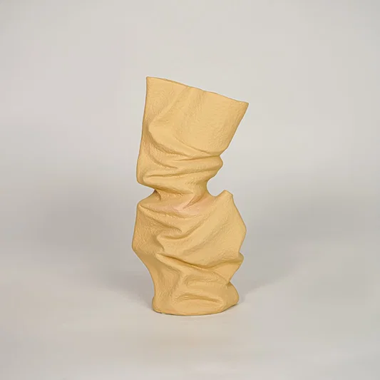Beige ceramic decorative vase with abstract twisted design for modern console table and shelf decor placement.