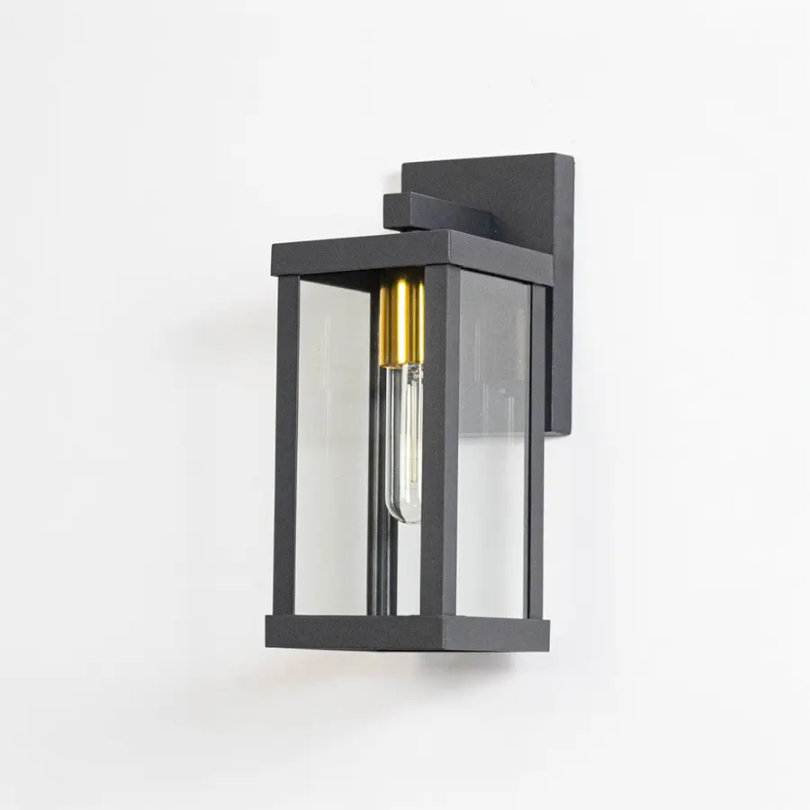 Black metal exterior wall light switched off on white background emphasizing minimal design and sturdy metal construction.