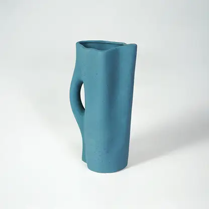 White background image of blue ceramic abstract vase for modern tabletop decor styling with matte finish.