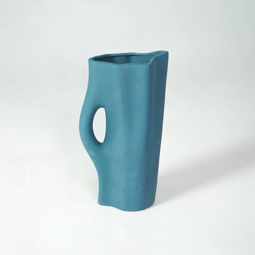 White background image of blue ceramic modern vase for contemporary interior decor styling with artistic finish.