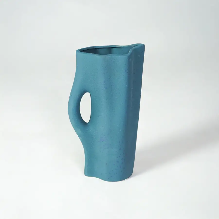 White background image of blue ceramic modern vase for contemporary interior decor styling with artistic finish.