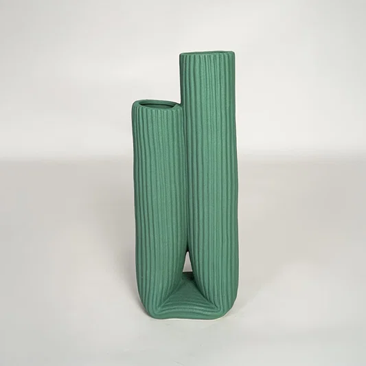 Modern green ceramic dual opening vase with ribbed surface ideal for shelf styling and contemporary decor display.