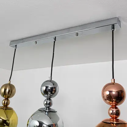Amber smoke and metallic glass pendant lights showcasing refined modern lighting designs.
