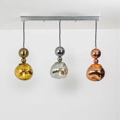 Gold silver and copper metallic glass pendant lights showcasing elegant contemporary home decor.