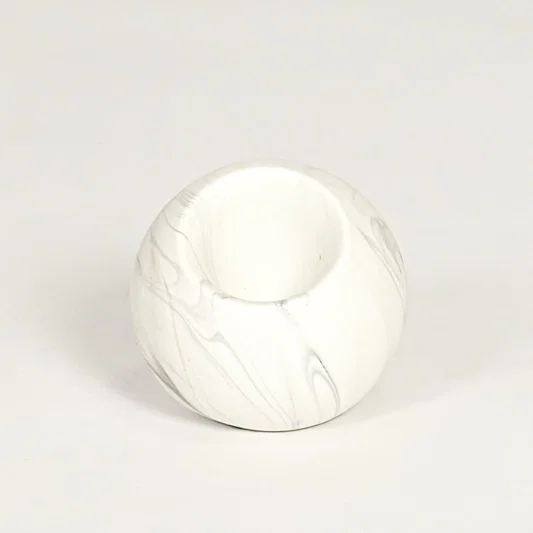 Modern white marble look ceramic vase with spherical body isolated on white background for tabletop styling.