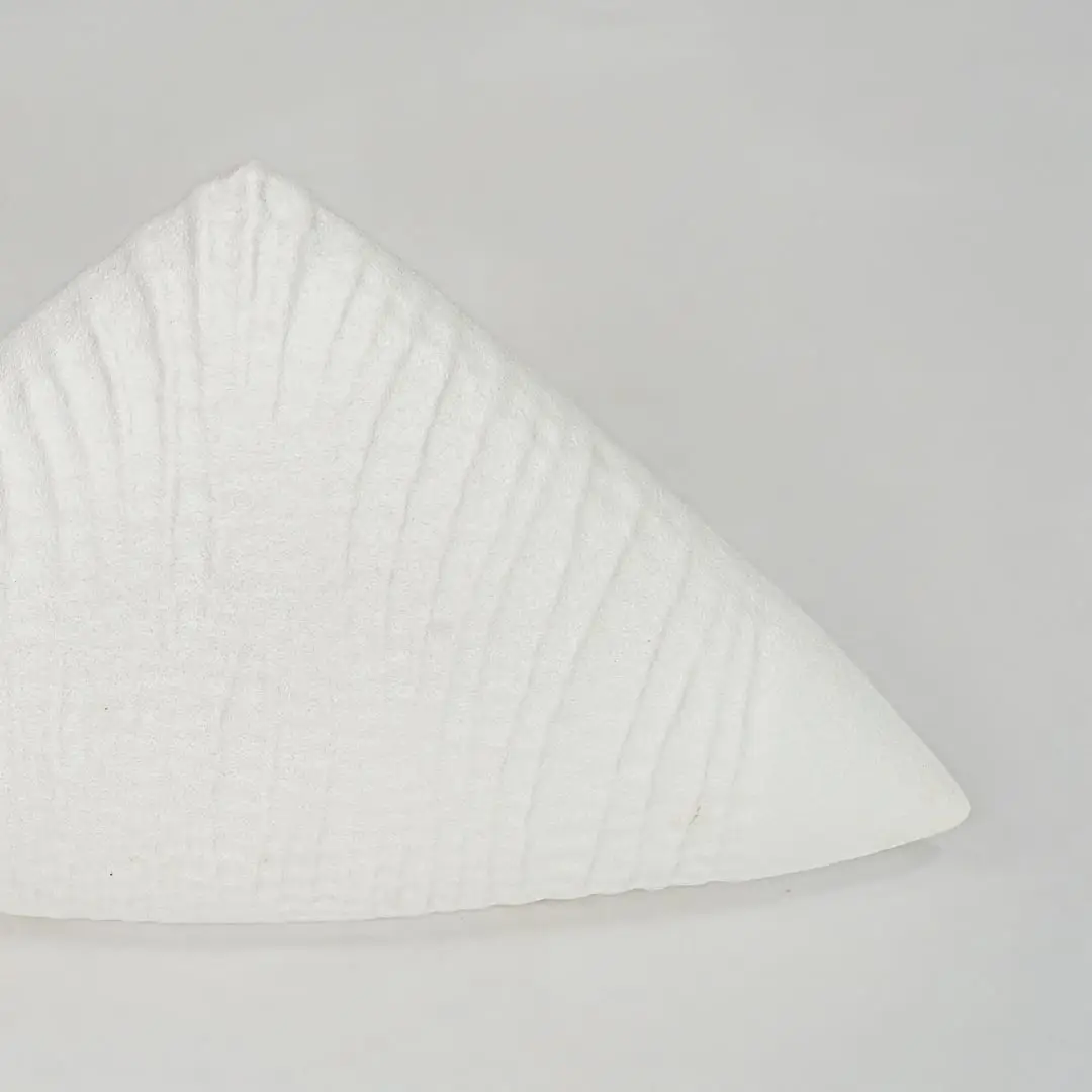 Closeup white textured ceramic decor piece surface detail modern decorative object for table shelf console decor.