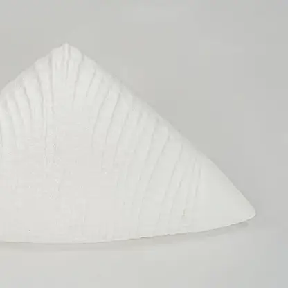 Closeup white textured ceramic decor piece surface detail modern decorative object for table shelf console decor.