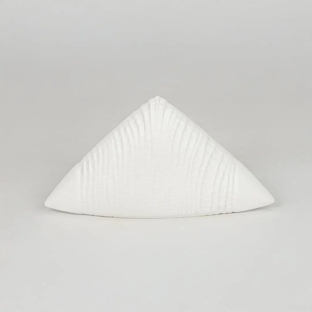 Modern white decorative ceramic showpiece isolated clean background stylish home decor accent piece.