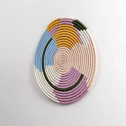 Natural woven pastel seagrass wall basket for living room hallway and boho décor on white background image.