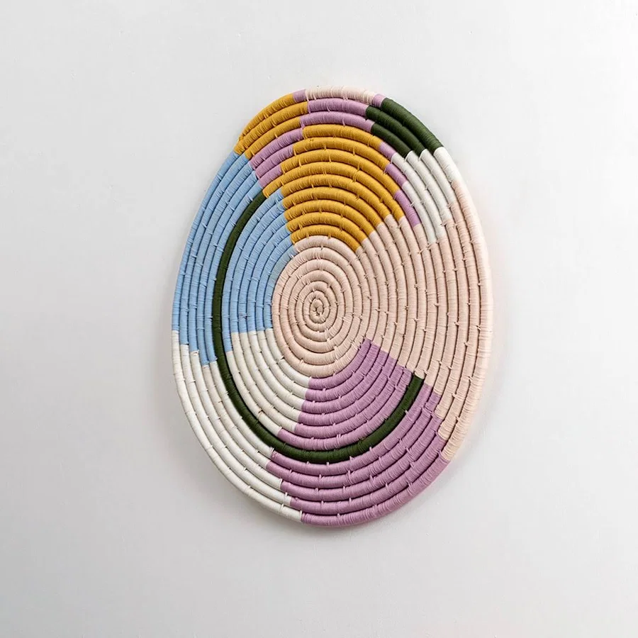Natural woven pastel seagrass wall basket for living room hallway and boho décor on white background image.